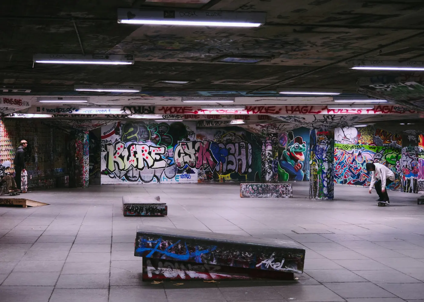 A concrete skate hall with graffiti walls